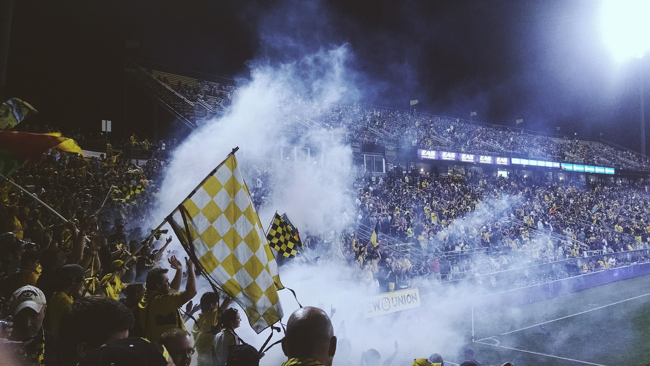 Crowded stadium under lights — public bias creates the spreads sharps quietly exploit week after week