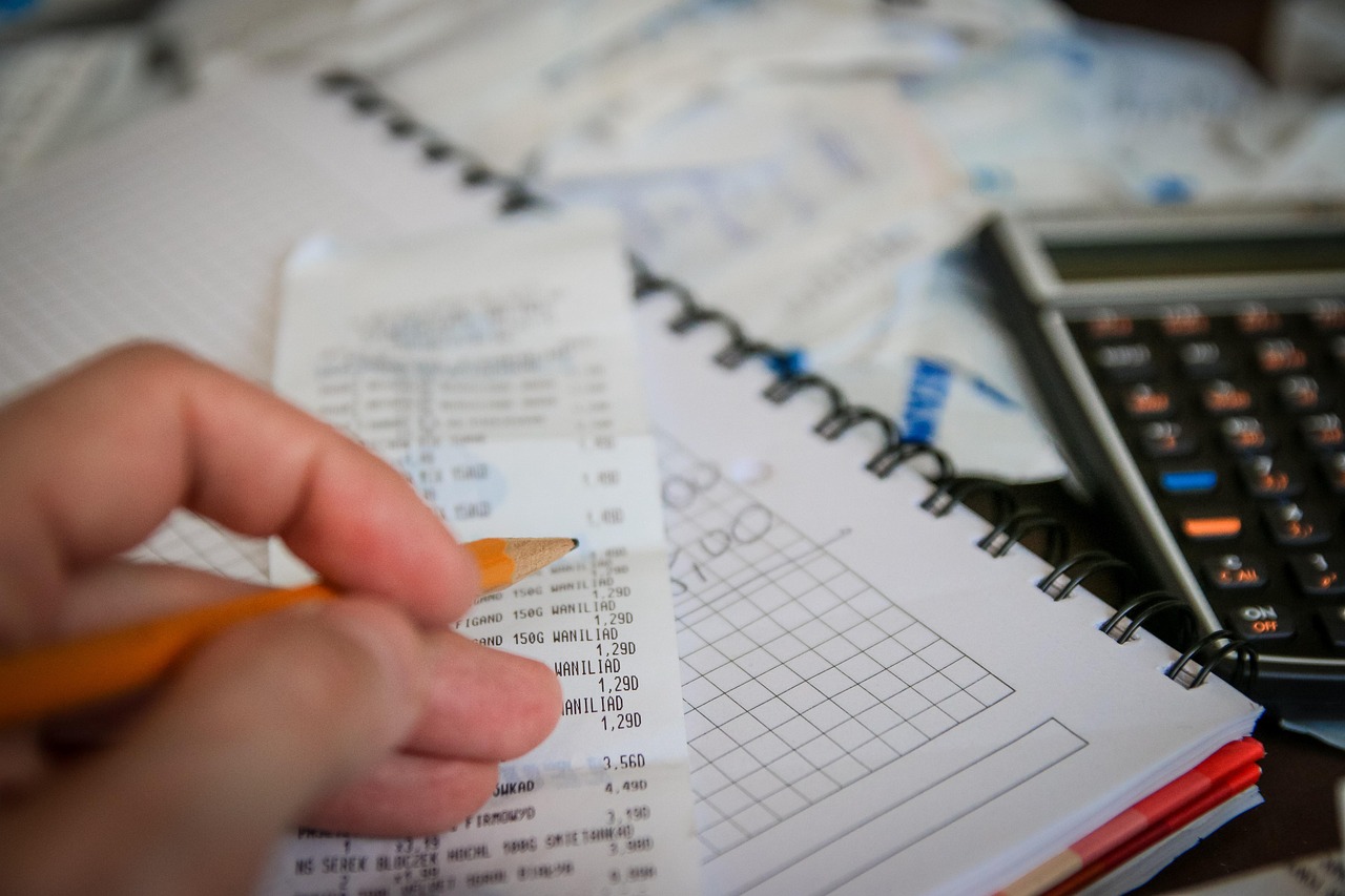 Calculator and cash on a desk — vig is the silent commission baked into every sportsbook price